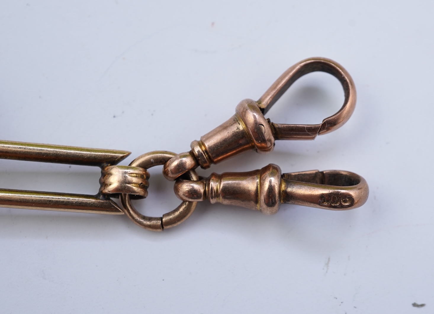 A continental 18k gold open faced keyless lever pocket watch, with a 9ct albert